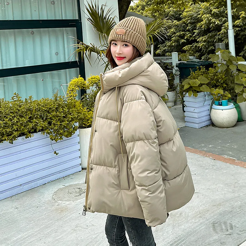 Stylish hooded puffer jacket for women with a relaxed-fit and zip-up closure